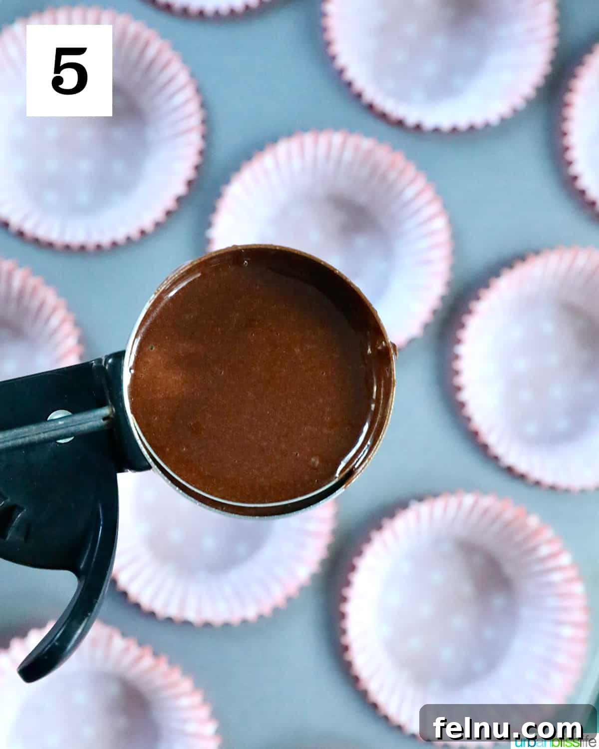 Reindeer Delight Cupcakes 9 Using a cookie scoop to fill a muffin tin with chocolate cupcake batter
