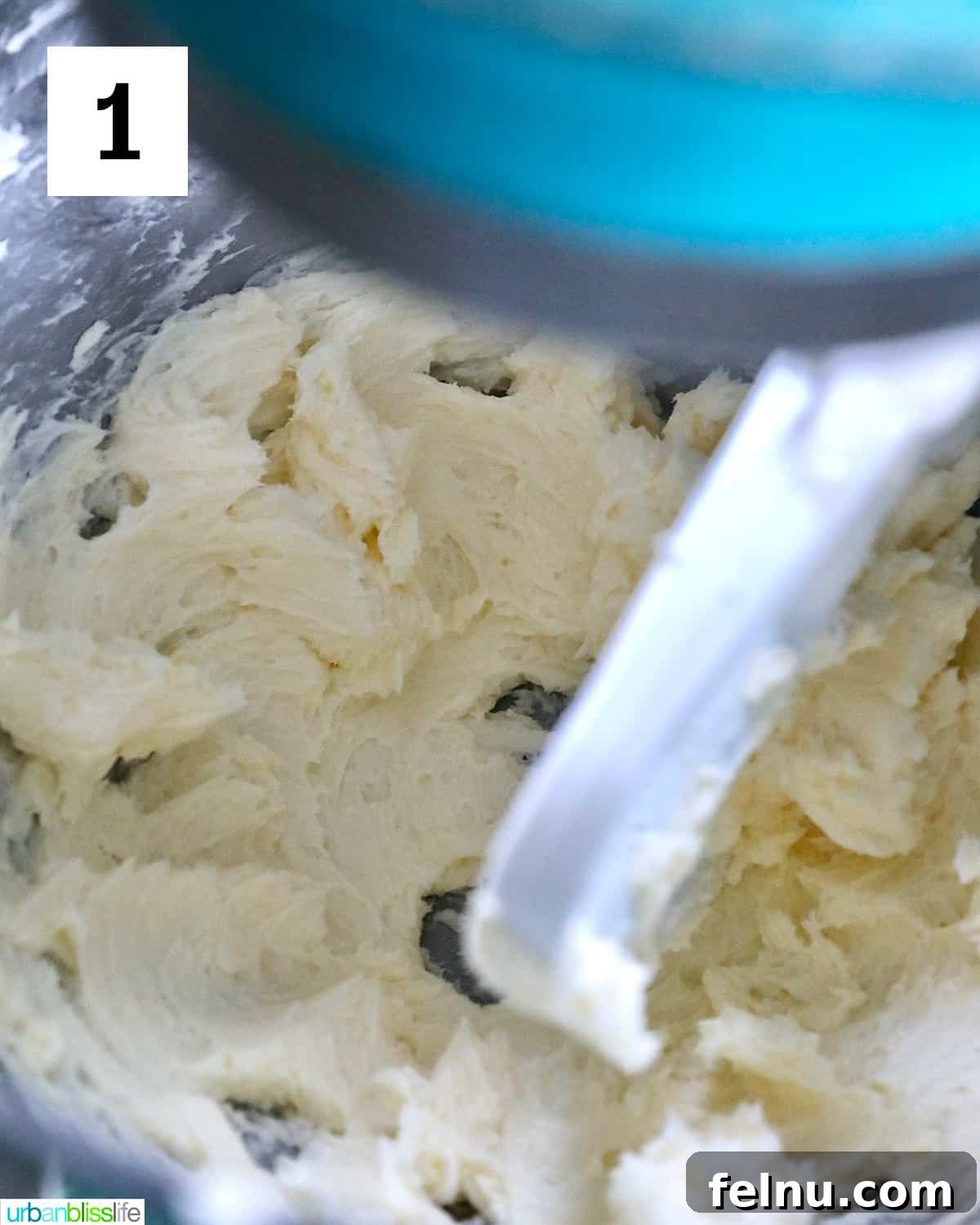 Effortless Decadent Chocolate Buttercream 5 A stand mixer in action, creaming softened butter until it turns light yellow and fluffy, the crucial first step for smooth buttercream frosting.