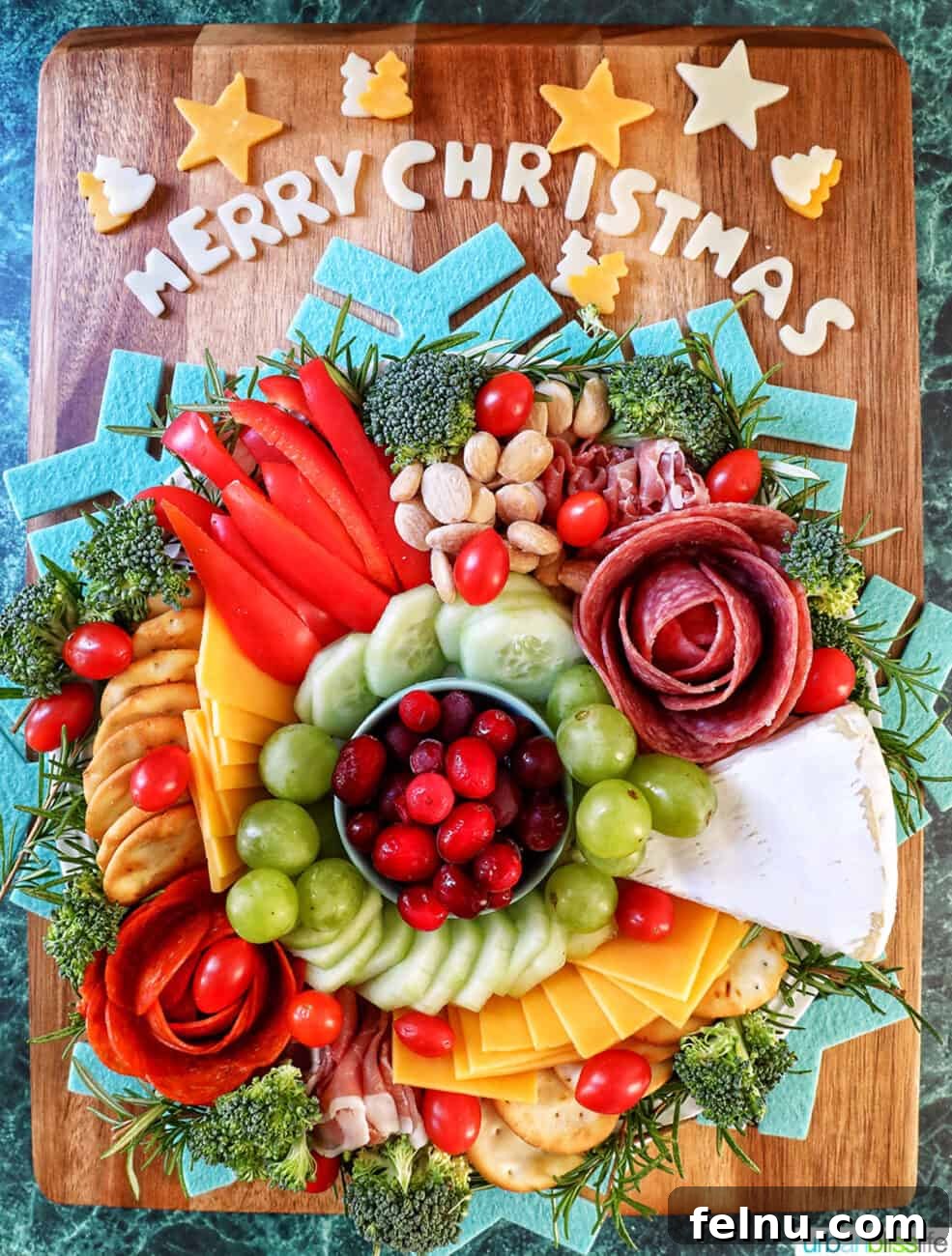 A Festive Christmas Snack Board 2 A beautifully arranged Christmas charcuterie board featuring a variety of meats, cheeses, fresh fruits, vegetables, and nuts, perfect for holiday entertaining.