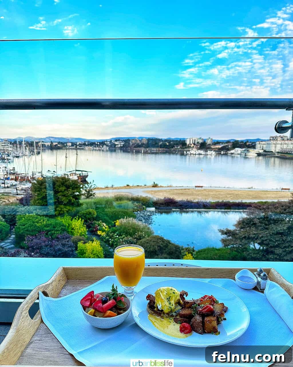 Breakfast room service with a view of Victoria Harbour from a suite at the Inn at Laurel Point hotel, featuring a delectable spread.