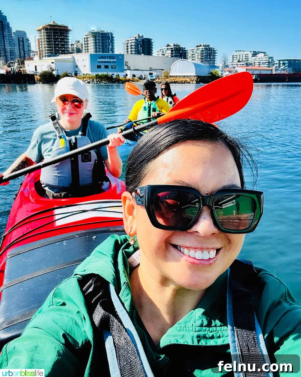 Marlynn and other journalists kayaking on the calm waters of Victoria Harbour, enjoying the cityscape.