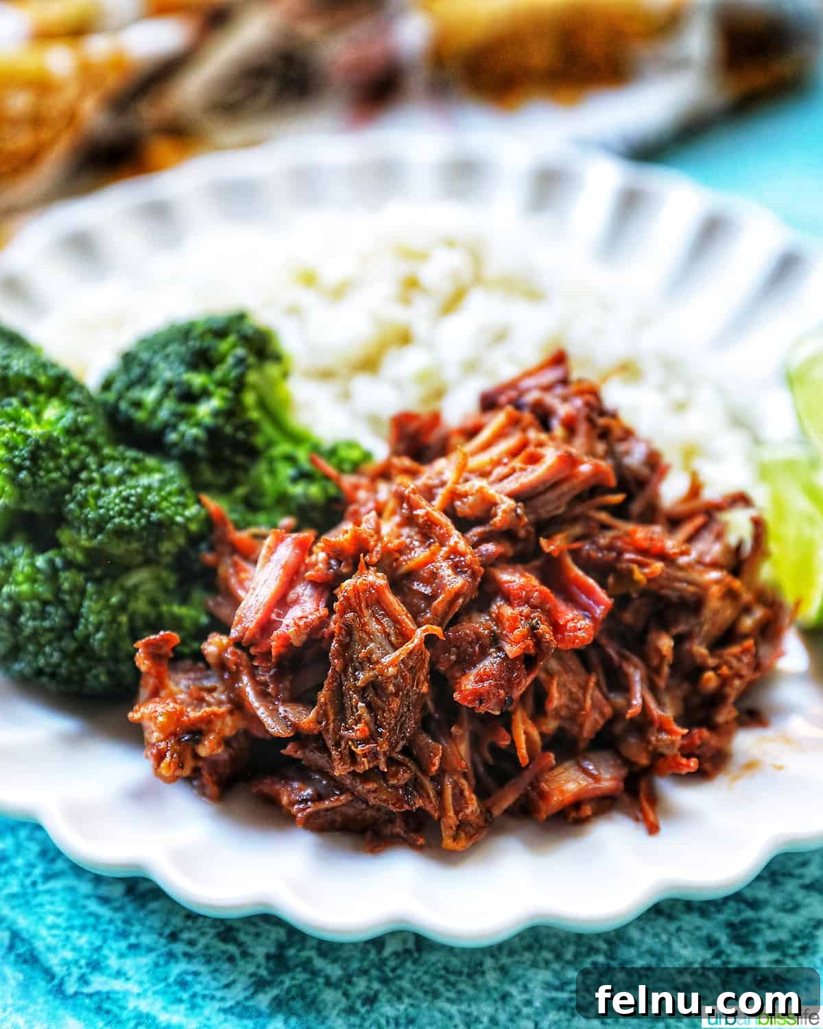 Slow-Cooker Fiesta Shredded Beef 2 Mexican shredded beef served with rice and broccoli.