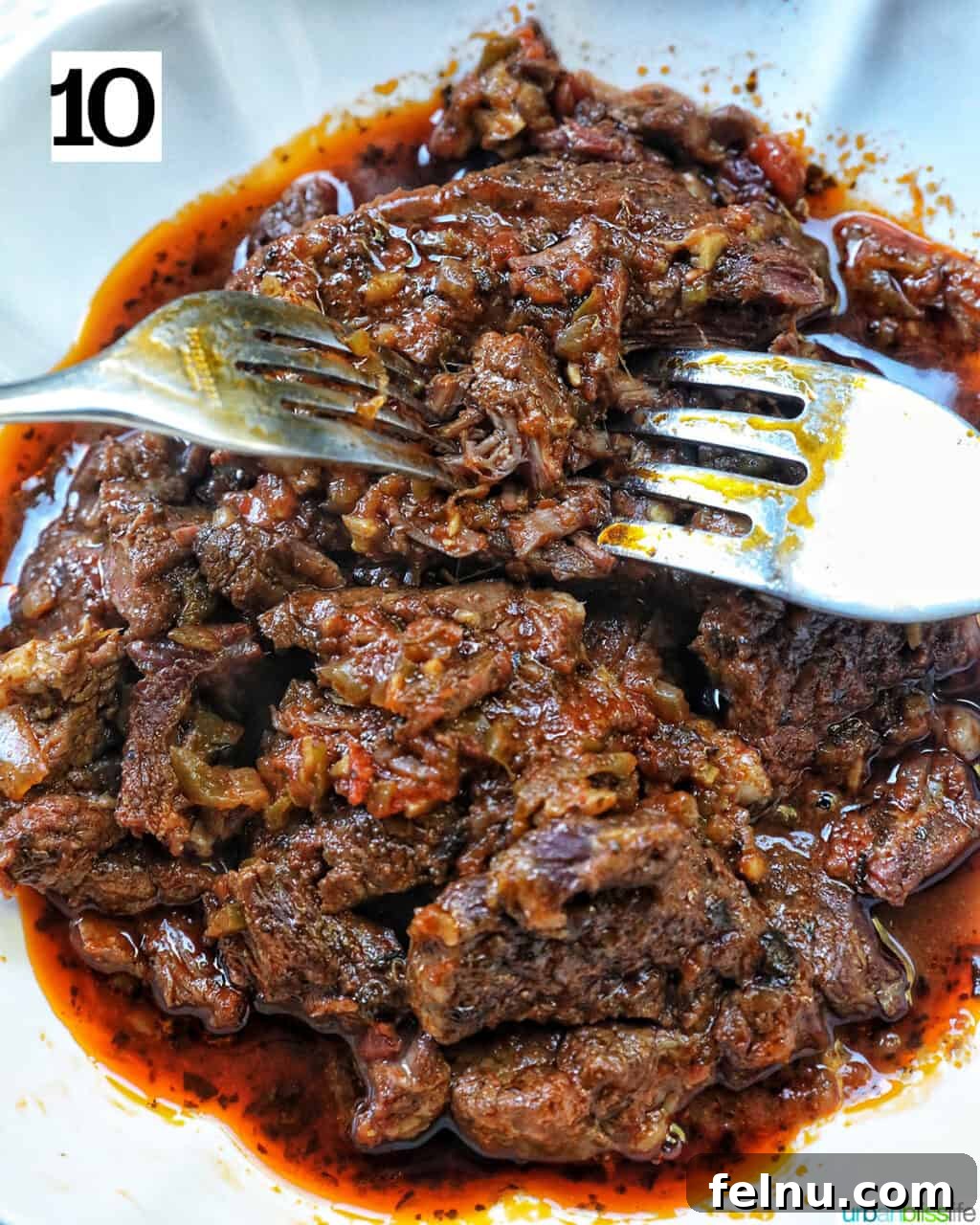 Slow-Cooker Fiesta Shredded Beef 14 Shredding Mexican beef with two forks.
