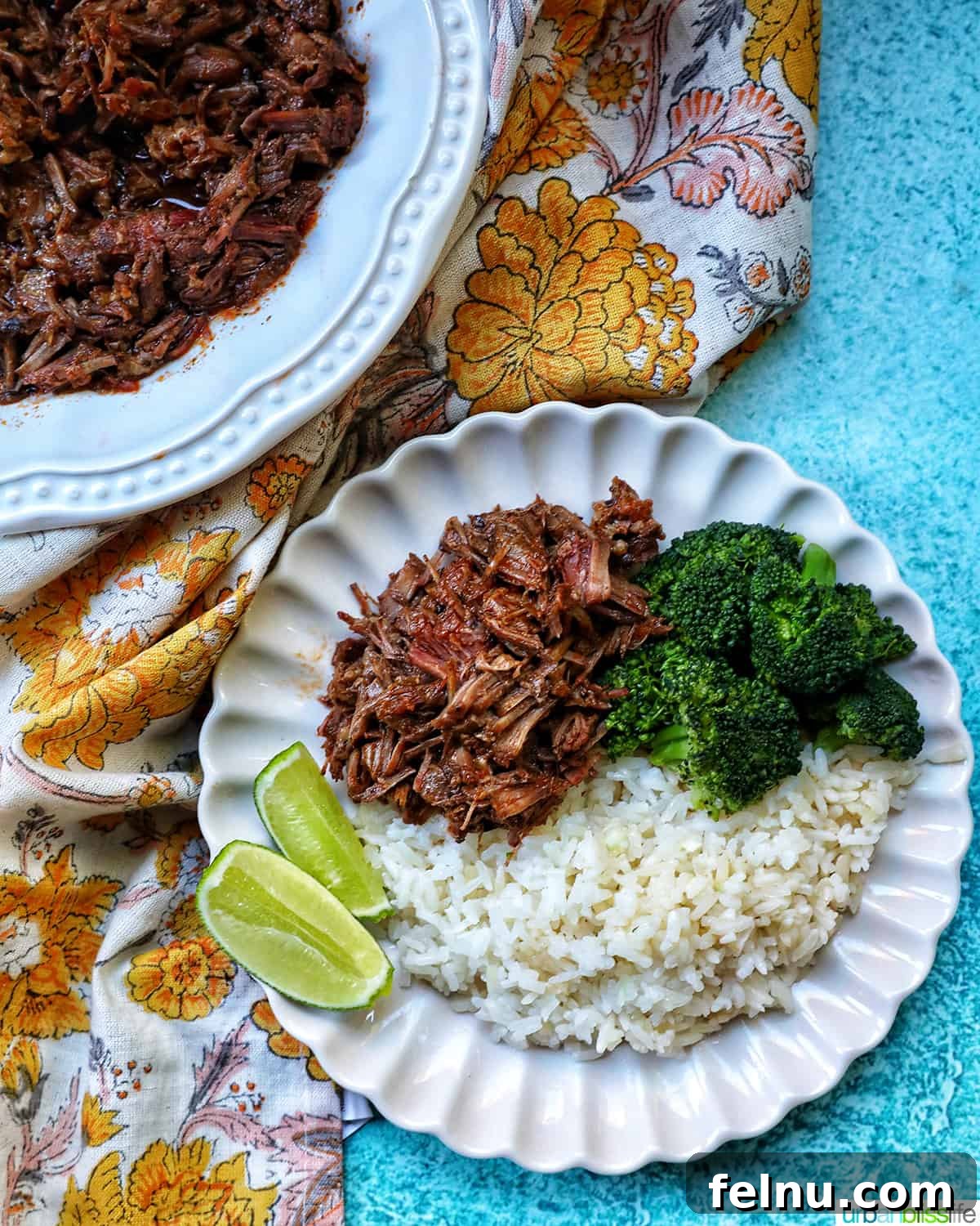 Slow-Cooker Fiesta Shredded Beef 15 Overhead shot of Mexican shredded beef with rice and broccoli.