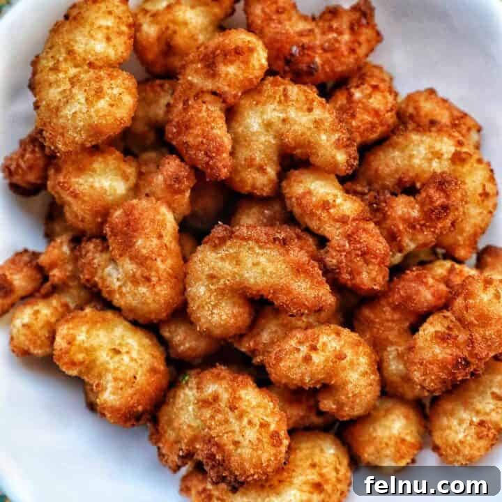 Crispy Air Fryer Popcorn Shrimp 11 A bowl filled with perfectly air-fried popcorn shrimp, golden and crispy.