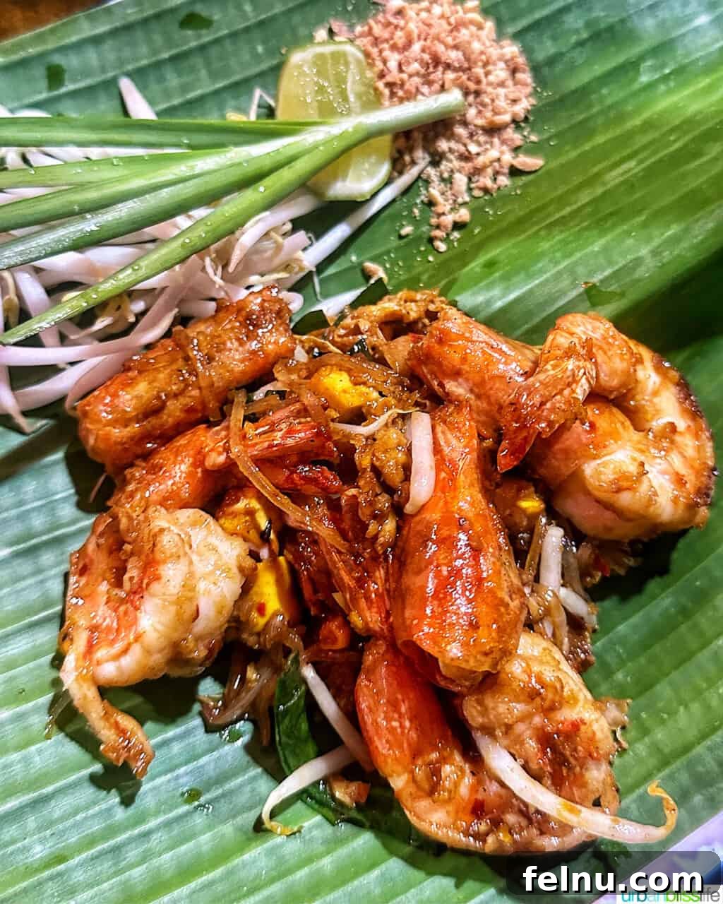 The Quest for Bangkok's Perfect Pad Thai 2 shrimp pad thai in Bangkok, on a bed of banana leaves.