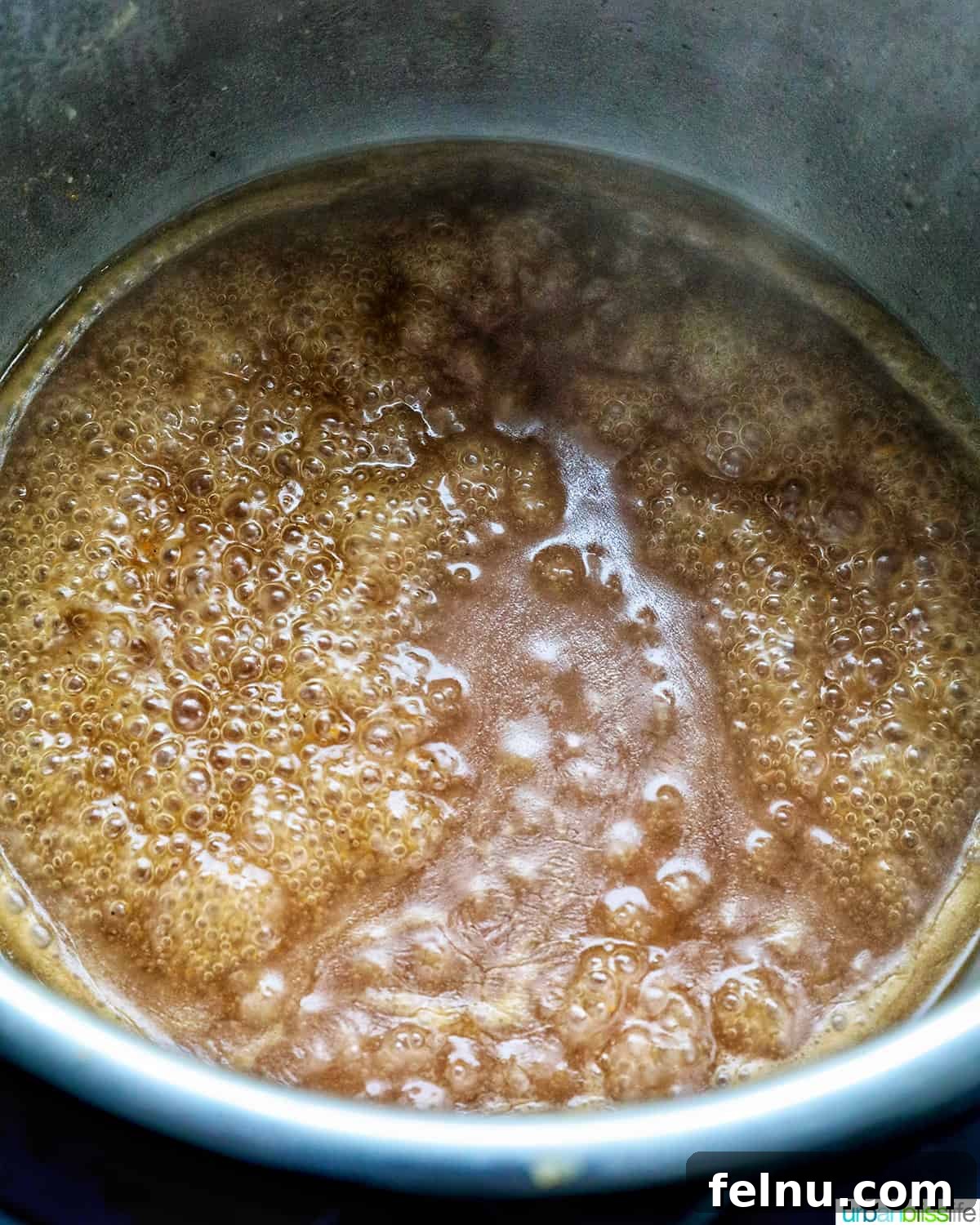 Tender Instant Pot Sirloin Tip Roast 17 gravy bubbling and thickening in an Instant Pot.