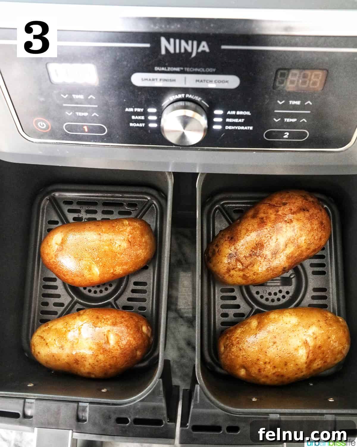 Crispy Fluffy Ninja Foodi Air Fryer Baked Potatoes 7 four baked potatoes in a Ninja Foodi airfryer.
