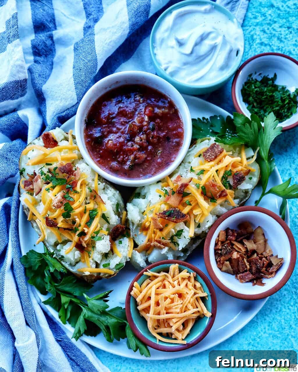 Crispy Fluffy Ninja Foodi Air Fryer Baked Potatoes 9 Loaded air fryer baked potato with title text overlay and sides of sour cream, cheddar cheese, parsley, and bacon.