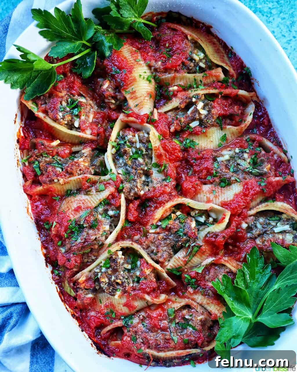 Hearty Dairy-Free Beef Stuffed Shells 2 A casserole dish full of generously stuffed shells with ground beef, rich marinara sauce, and a hint of fresh herbs.