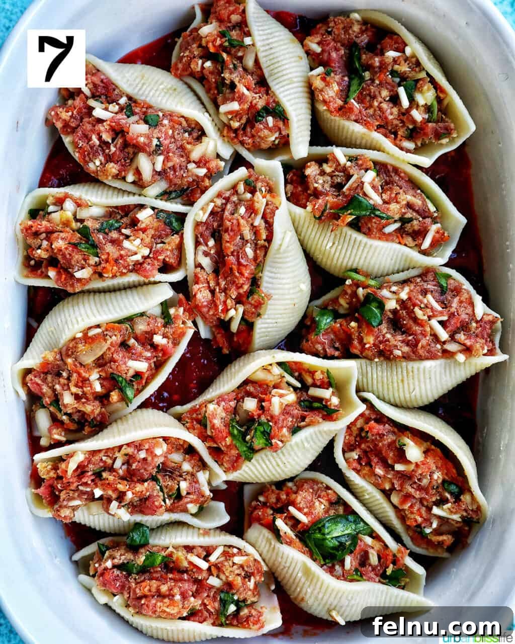Hearty Dairy-Free Beef Stuffed Shells 11 A casserole dish filled with uncooked stuffed shells with ground beef, neatly arranged and ready for the final sauce layer and baking.