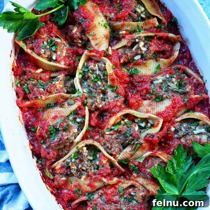 A casserole dish full of delicious stuffed shells with ground beef, ready to be served.