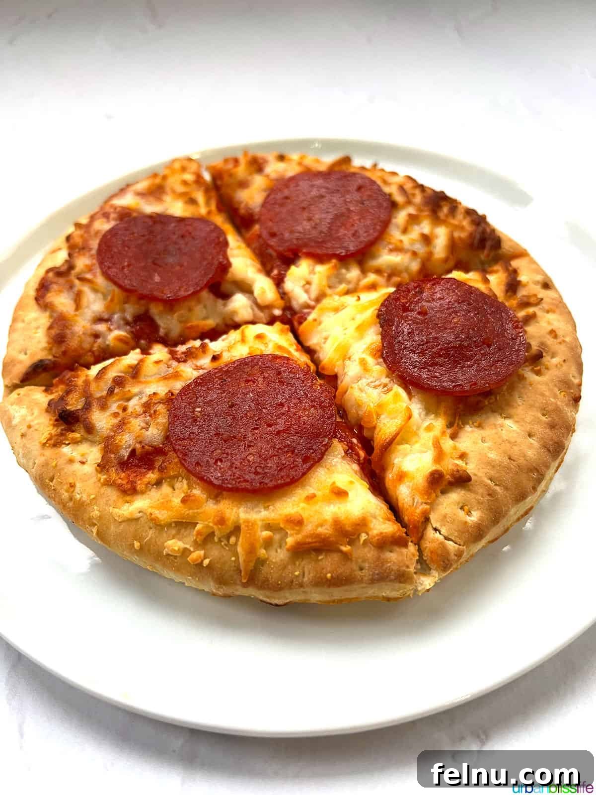 Air Fryer Pizza Perfection 3 Close-up of air fryer frozen pizza, highlighting the even cooking and bubbly cheese.