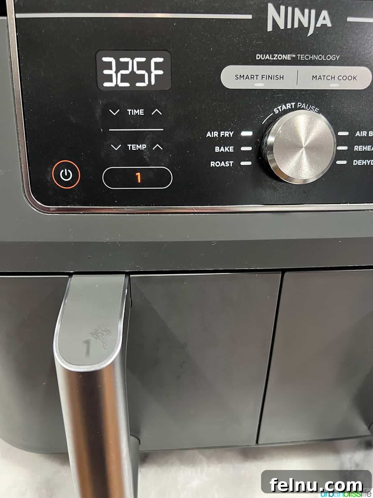 Air Fryer Pizza Perfection 6 Setting the Ninja air fryer to 325 degrees Fahrenheit for cooking the frozen pizza.