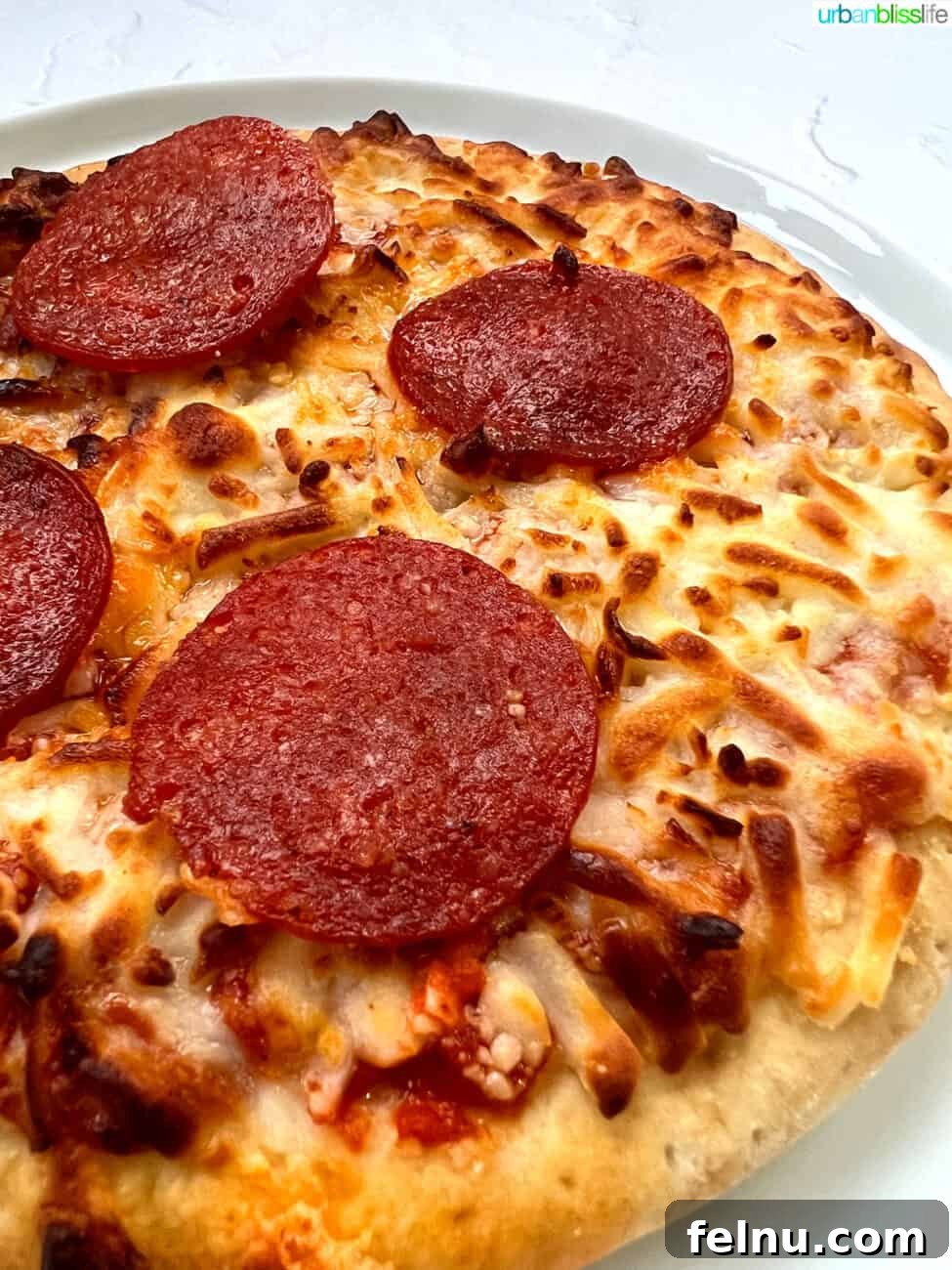 Air Fryer Pizza Perfection 7 Side view of the air fryer frozen pizza, showcasing the golden-brown crust.