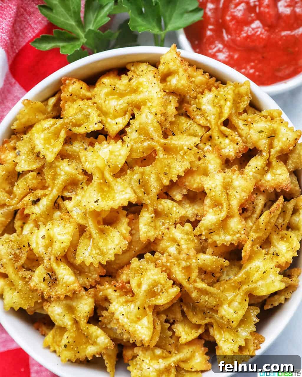 Air Fryer Pasta Chips
Crispy Air-Fried Pasta Snacks 2 Crispy Air Fryer Pasta Chips in a white bowl, ready to be devoured.