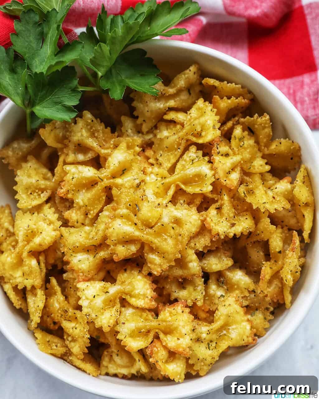 Air Fryer Pasta Chips
Crispy Air-Fried Pasta Snacks 13 Bowl of Air Fryer Pasta Chips in a white bowl garnished with parsley.