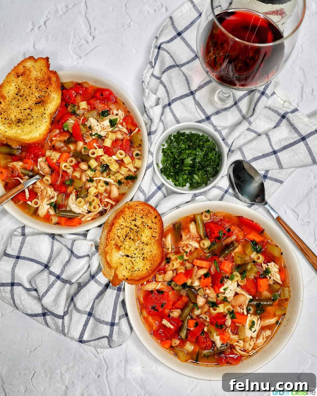 Chicken Minestrone Soup Delight 16 Chicken Minestrone Soup served alongside a glass of red wine and garlic bread, suggesting a delightful pairing for a complete dining experience.