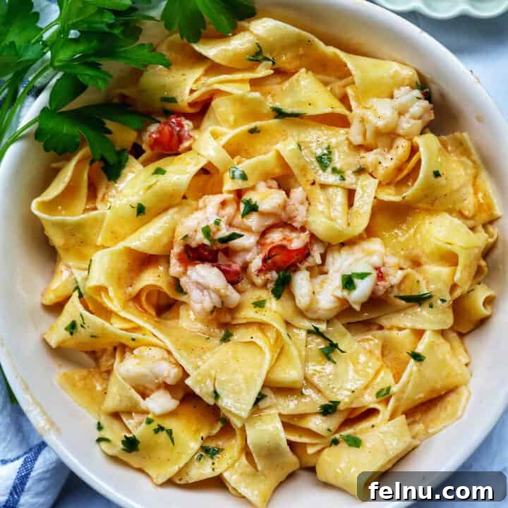 bowl of lobster pasta with side of parsley.