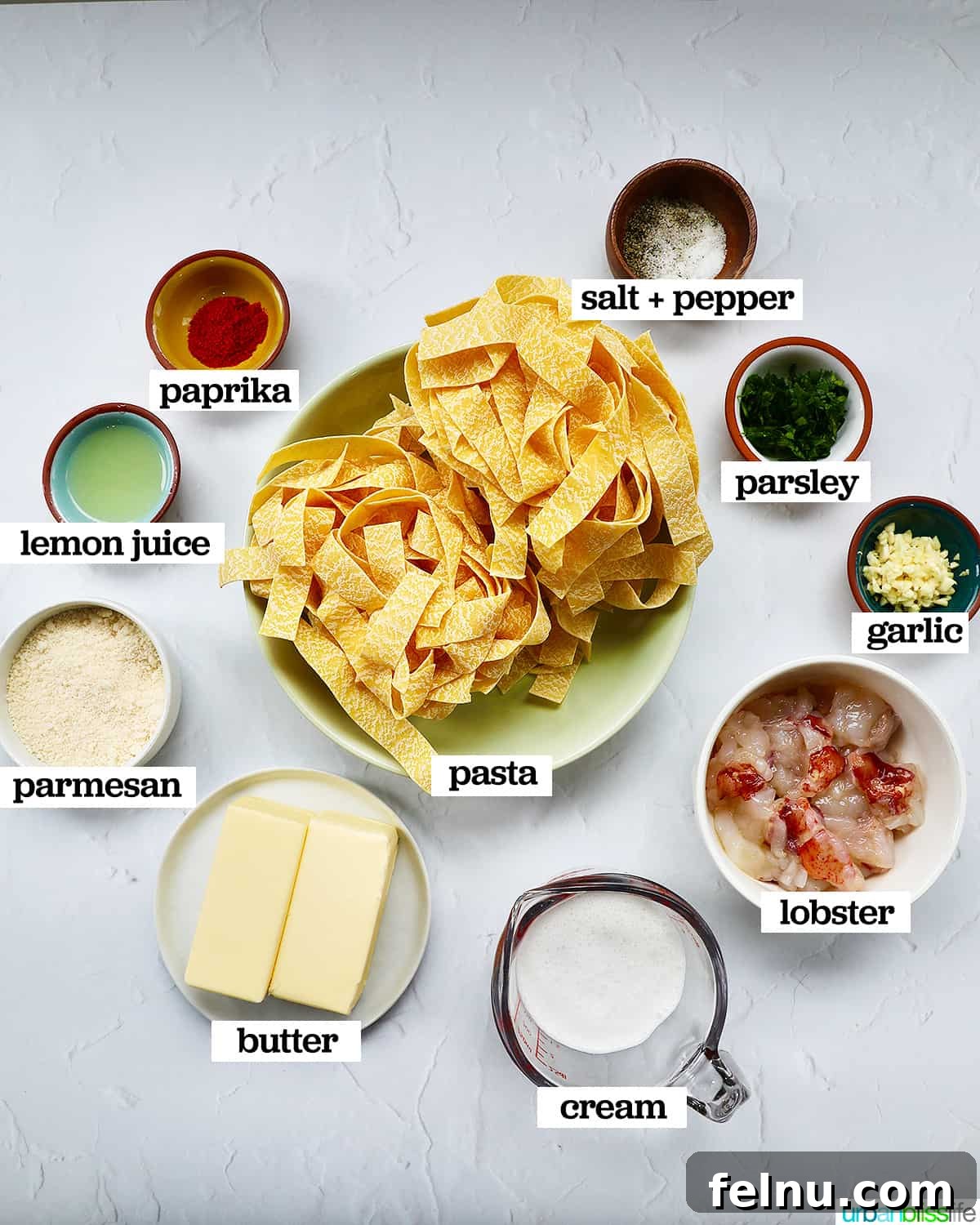 Luxurious Lobster Pasta 4 bowls of individual ingredients to make lobster pasta, neatly arranged.