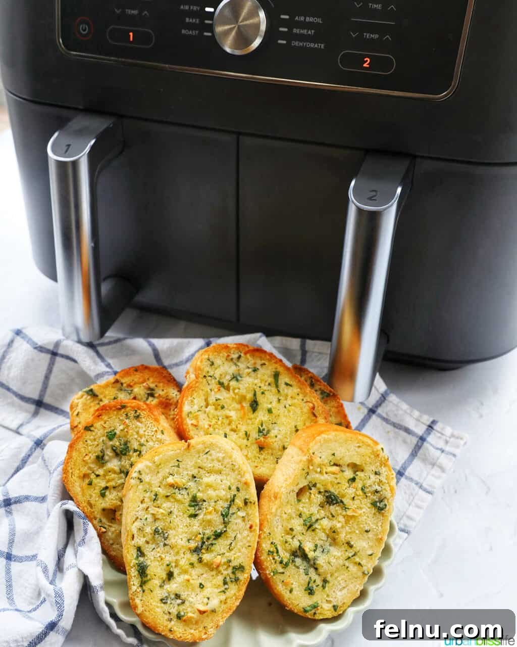 Air Fryer Garlic Toast 11 Air fryer garlic bread served in front of a Ninja Foodi air fryer.