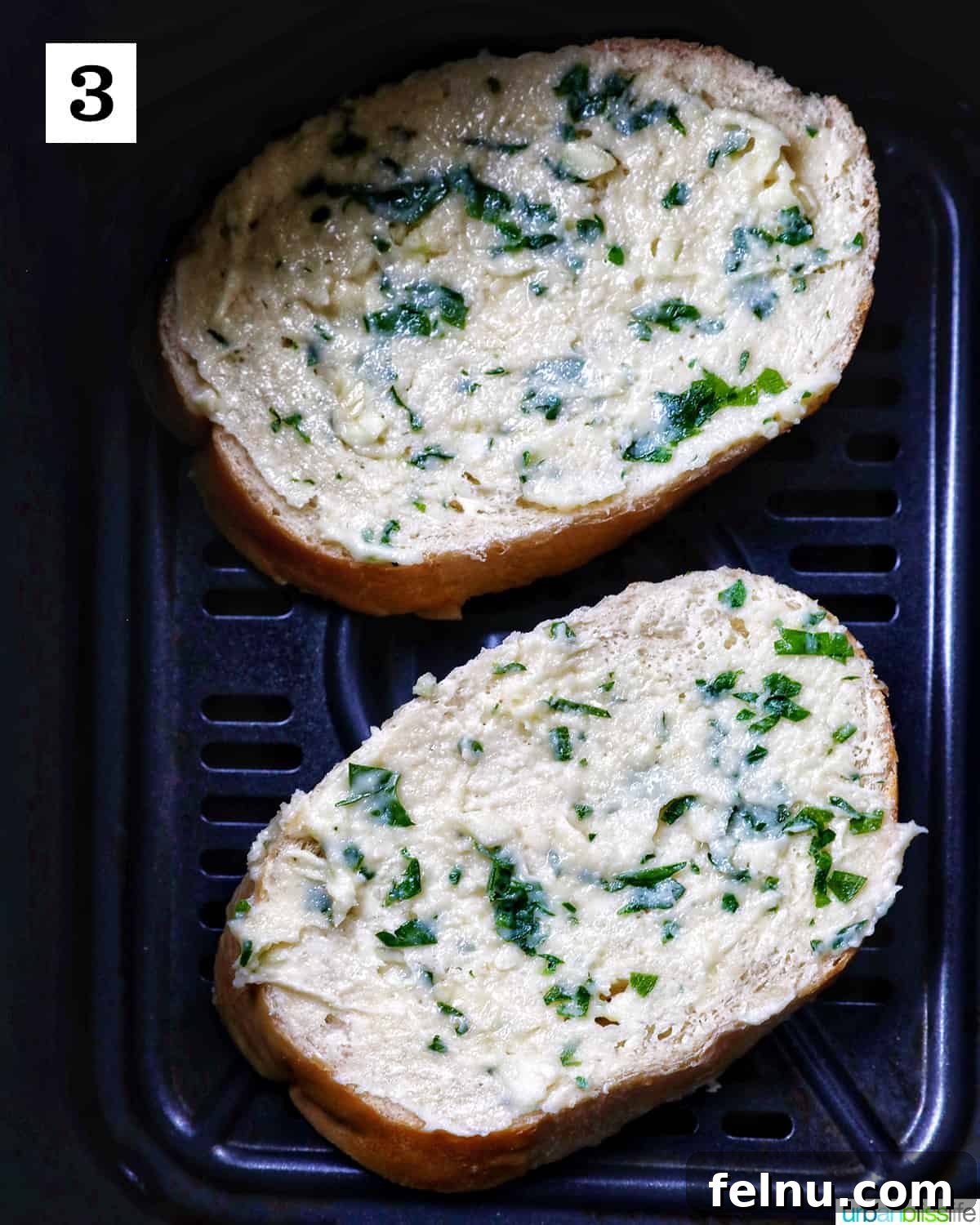 Air Fryer Garlic Toast 8 Two slices of garlic bread in the air fryer basket.