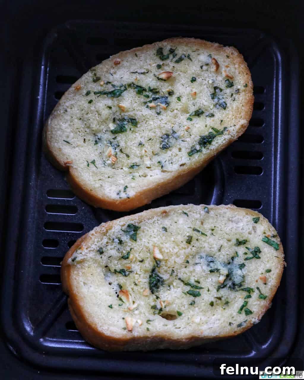 Air Fryer Garlic Toast 9 Air fryer garlic bread in the air fryer basket, cooked to perfection.