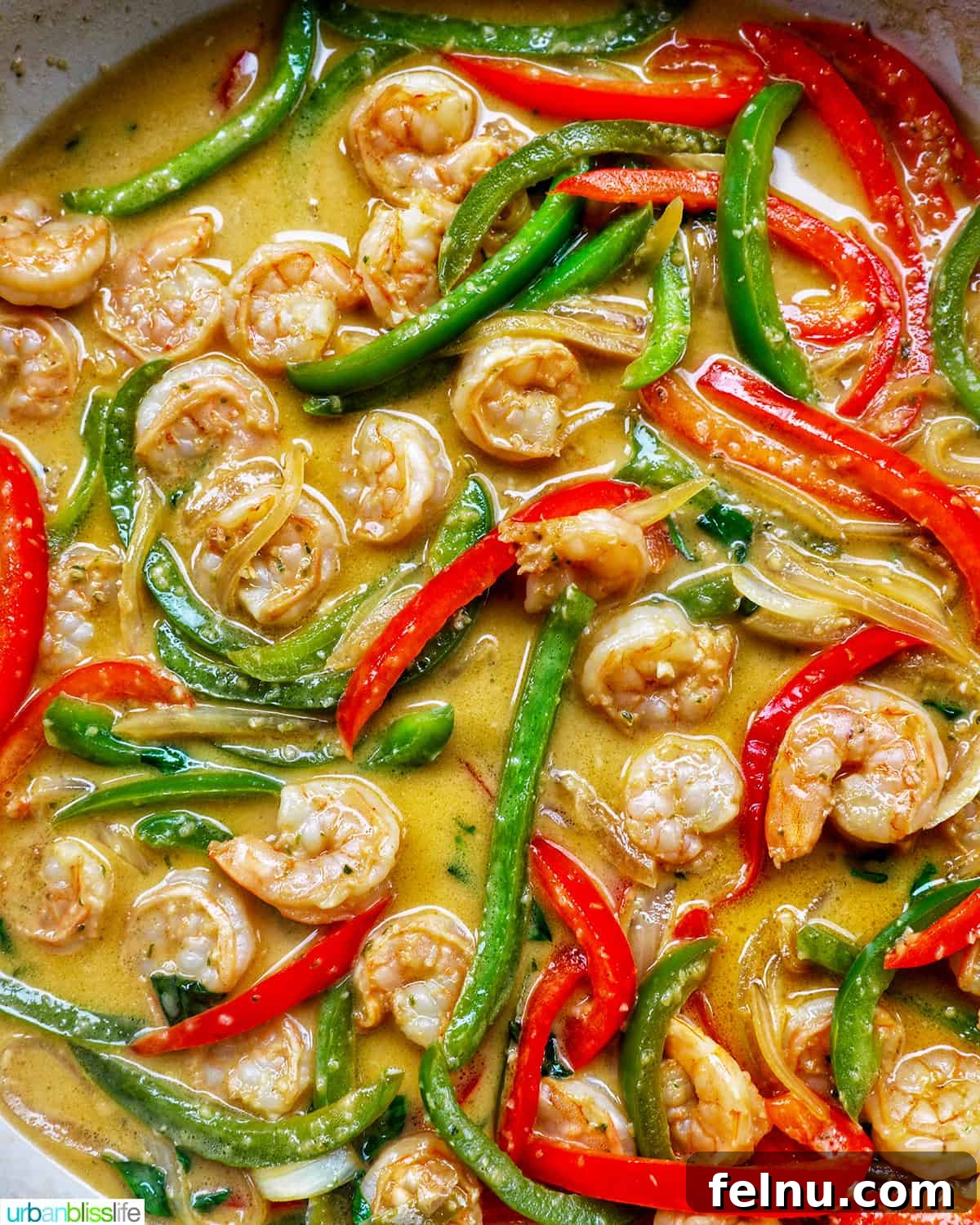 Thai Basil Prawn Stir-Fry 13 Thai Basil Shrimp cooking in a pan with a rich sauce.