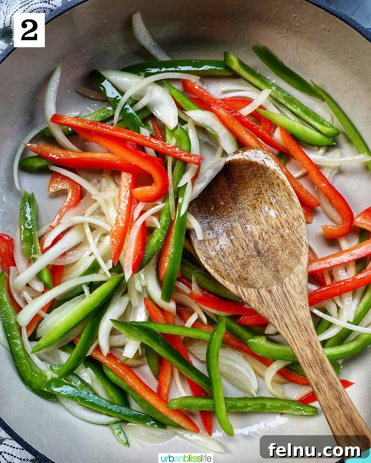 Thai Basil Prawn Stir-Fry 7 Sautéing onions, red peppers, and green peppers in a wok.