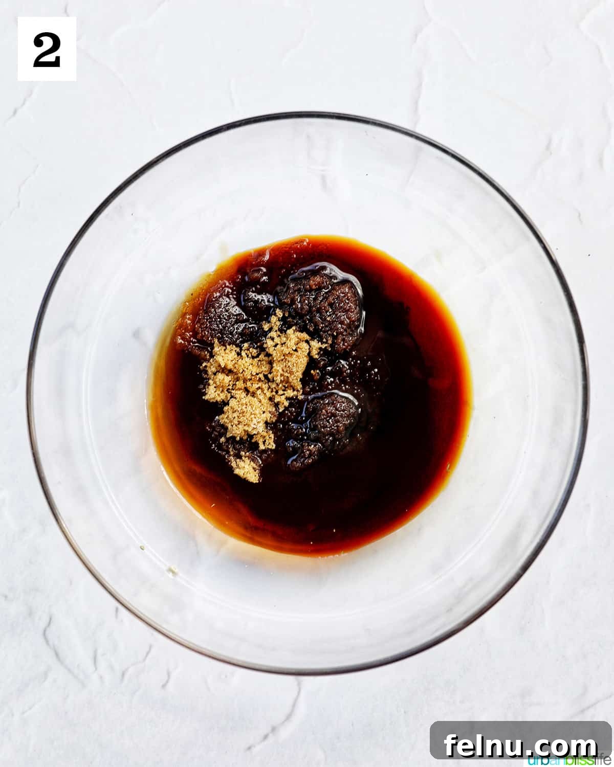 Savory Thai Beef Pad See Ew Noodles 6 A glass bowl filled with the prepared Pad See Ew sauce, showing its rich, dark color and ready for mixing.