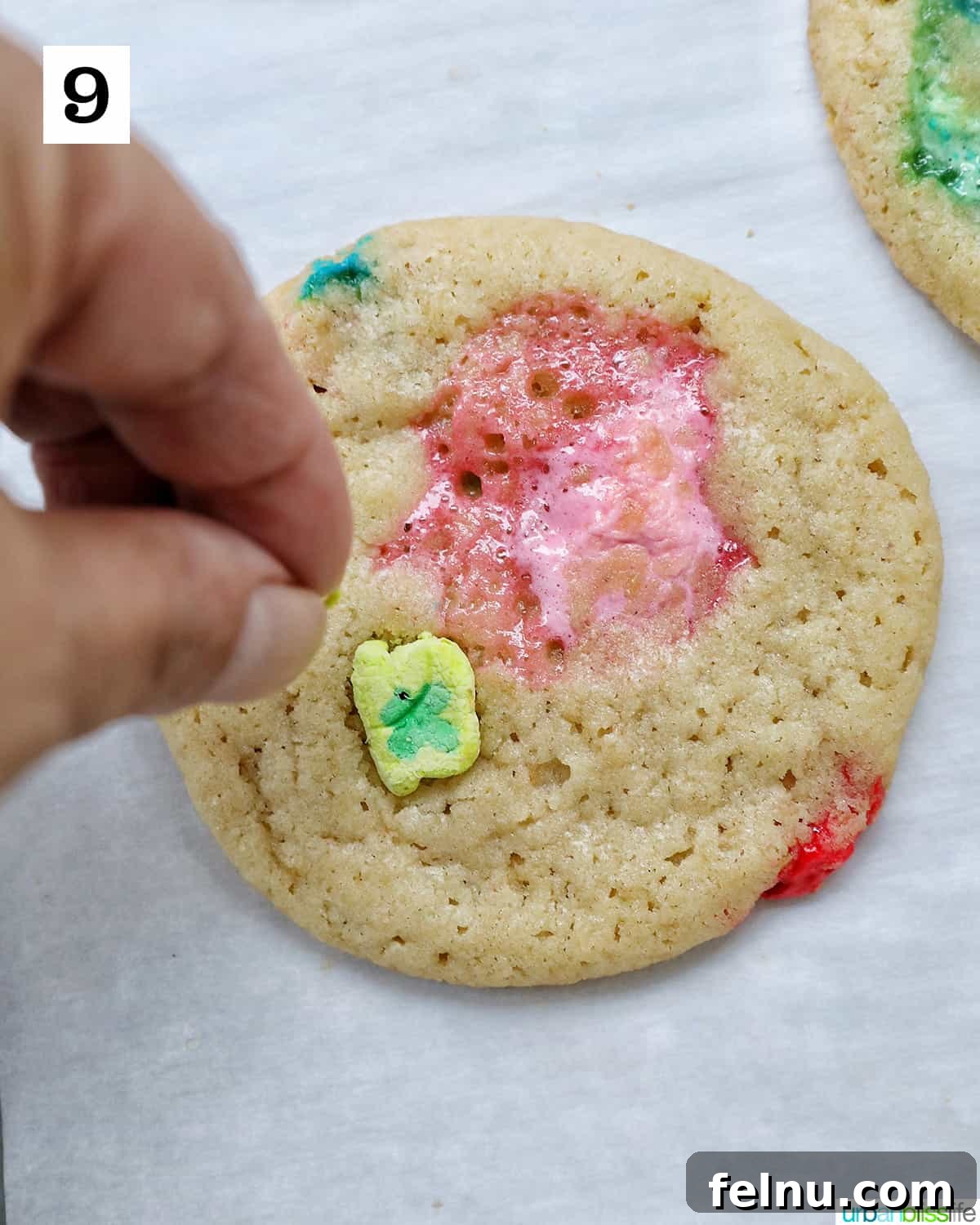 Lucky Charms Cookies 14 Pressing marshmallows onto a cookie.