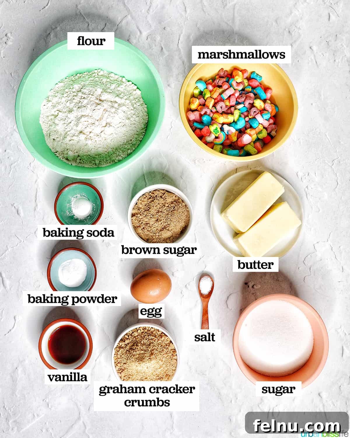 Lucky Charms Cookies 4 Bowls of ingredients for making Lucky Charms Cookies, showcasing the necessary components.