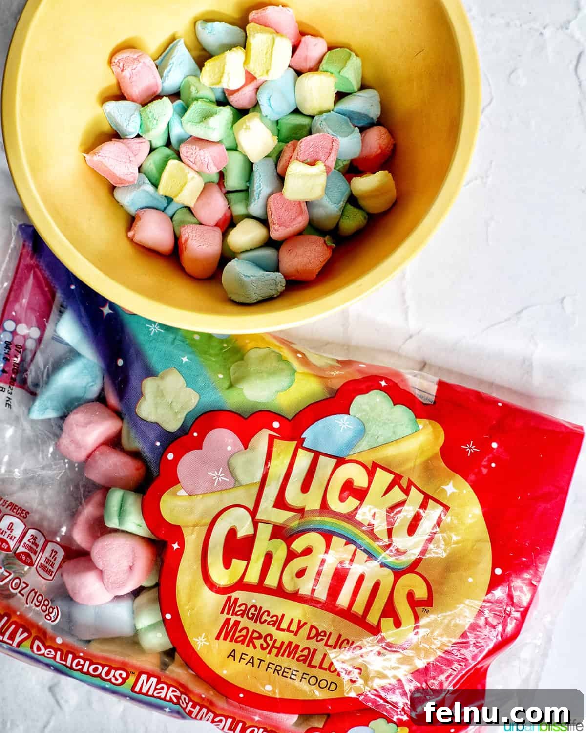 Lucky Charms Cookies 5 A bowl and a bag of Lucky Charms marshmallows, emphasizing the star ingredient.