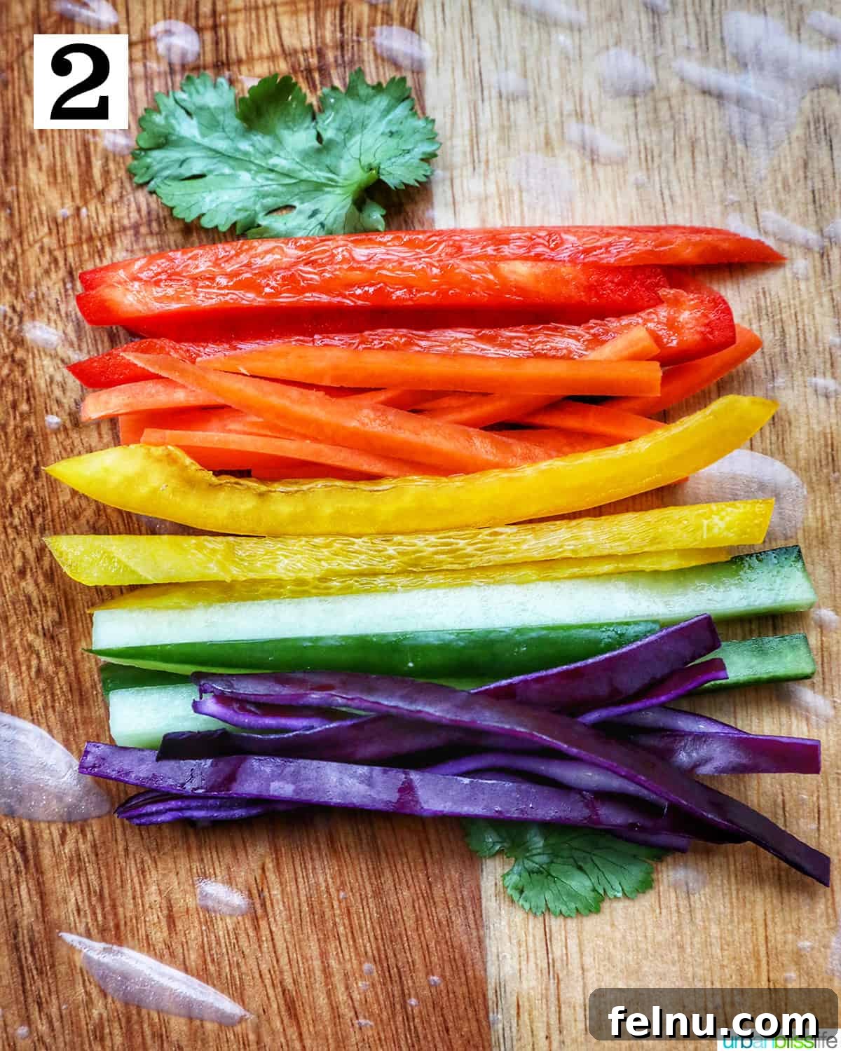 Vegan Delight: Fresh Summer Rolls 6 A rice paper roll topped with a colorful assortment of sliced vegetables on a wooden cutting board, creating a vibrant base for the remaining ingredients.