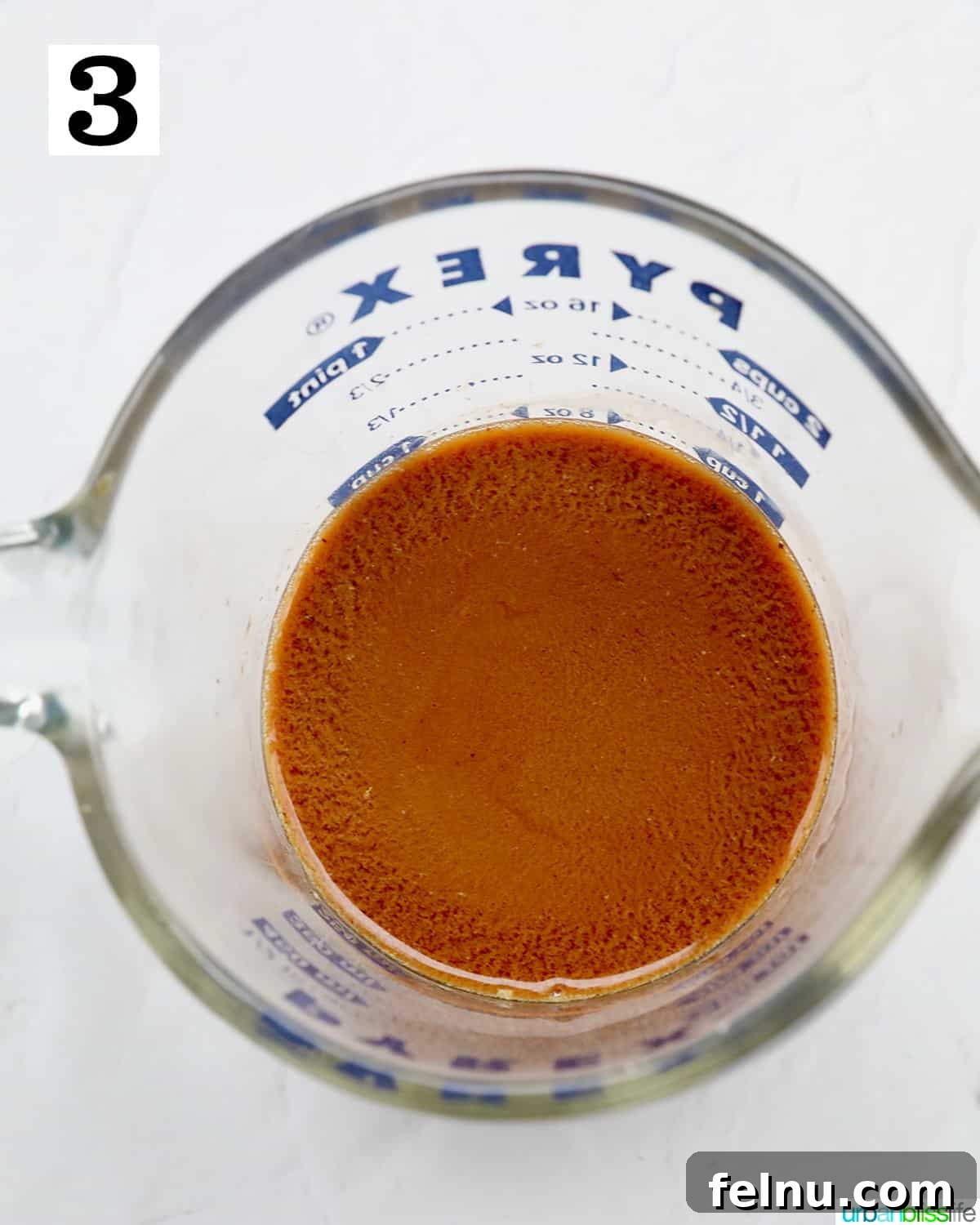 Emerald Isle Coffee Cake 10 A liquid measuring cup holding a perfectly mixed blend of instant coffee, Irish whiskey, and milk, ready to be incorporated into the cake batter.