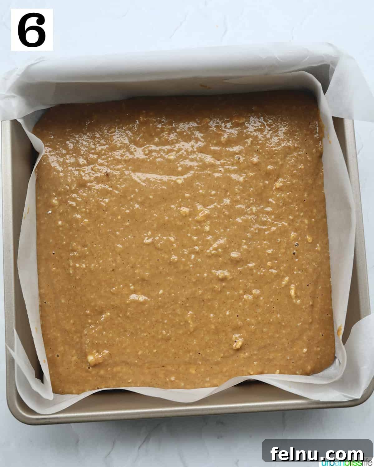 Emerald Isle Coffee Cake 15 Smooth, wet Irish coffee cake batter elegantly poured into a parchment paper-lined baking pan, preparing for the streusel topping.