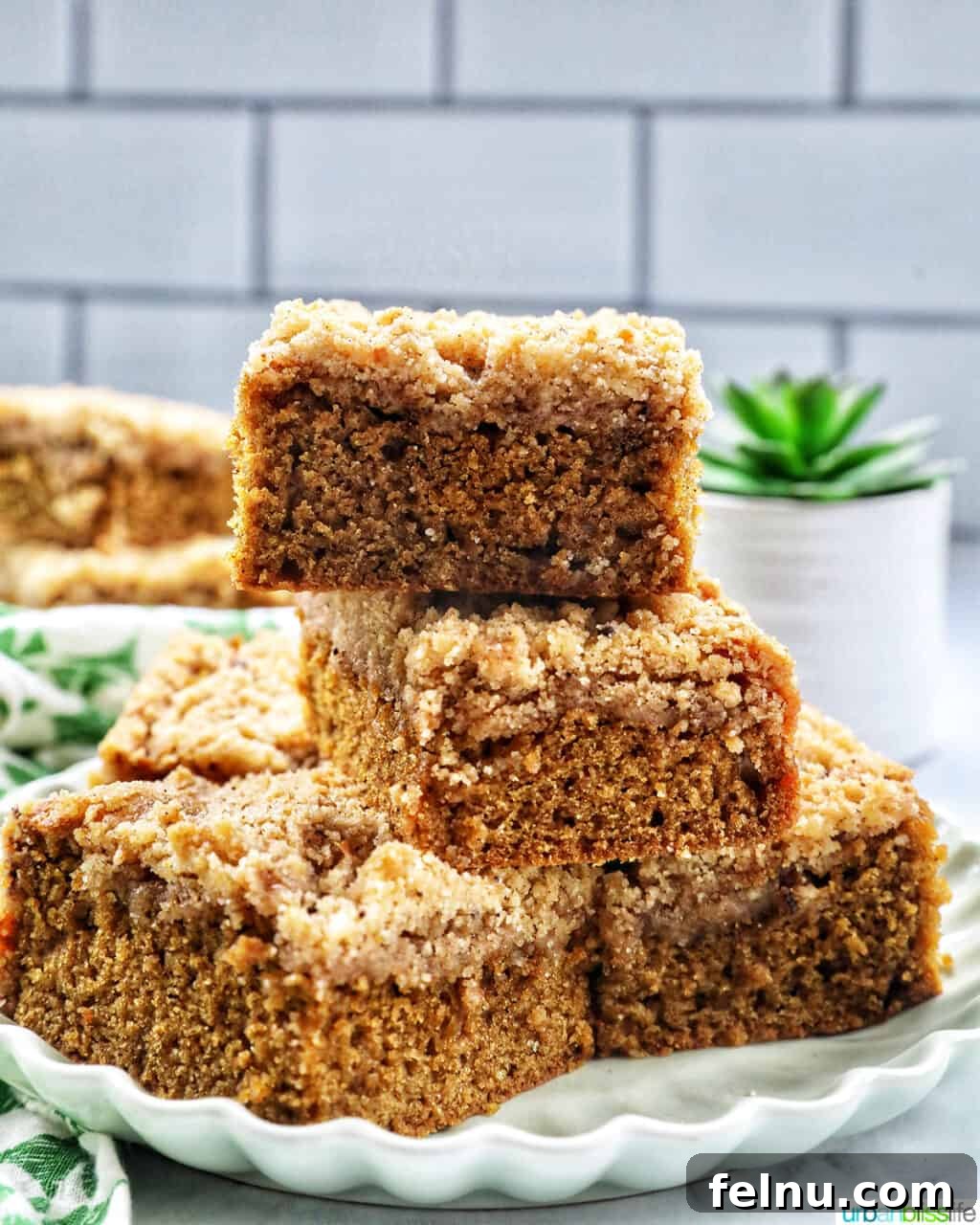 Emerald Isle Coffee Cake 18 A single stack of Irish coffee cake slices resting on a green plate, accompanied by green patterned napkins, highlighting its delightful texture and appearance.