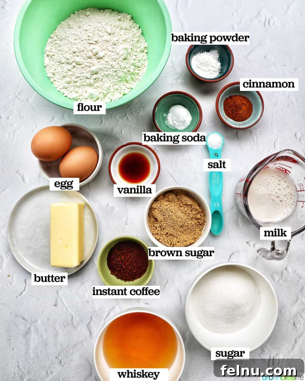 Emerald Isle Coffee Cake 5 A selection of bowls showcasing the key ingredients for making the Irish coffee cake itself, including flour, sugars, butter, eggs, and a bottle of Irish whiskey.
