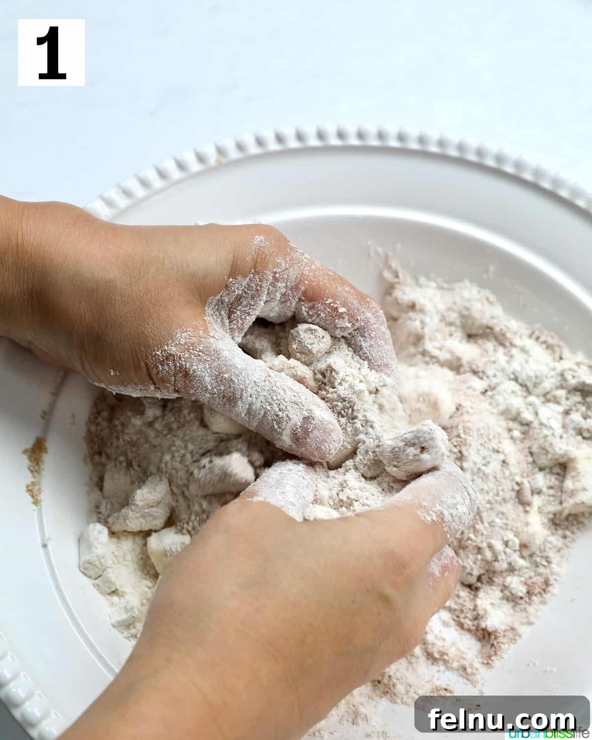 Emerald Isle Coffee Cake 7 Hands expertly pressing together the flour, sugars, and cold butter to form the crumbly streusel topping for the Irish coffee cake.