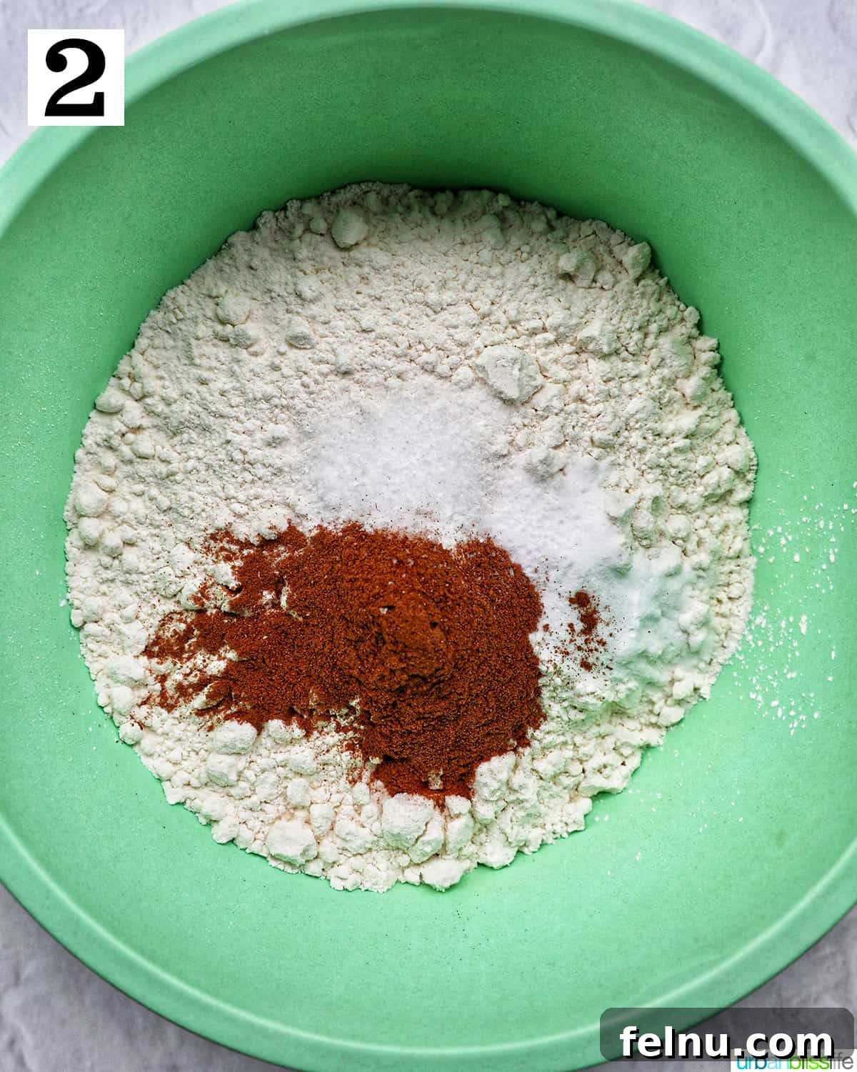 Emerald Isle Coffee Cake 9 A vibrant green bowl containing all the whisked dry ingredients for the Irish coffee cake, including flour, baking powder, and cinnamon.
