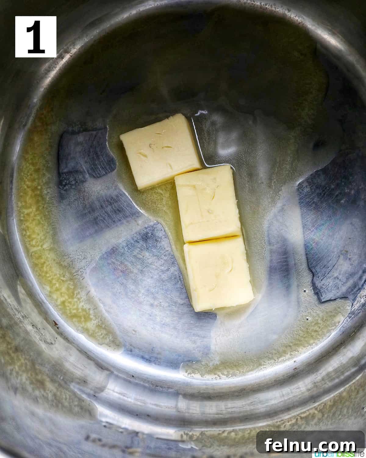 Effortless Instant Pot Cabbage 5 Three pats of unsalted butter melting and sizzling in the hot inner pot of an Instant Pot.