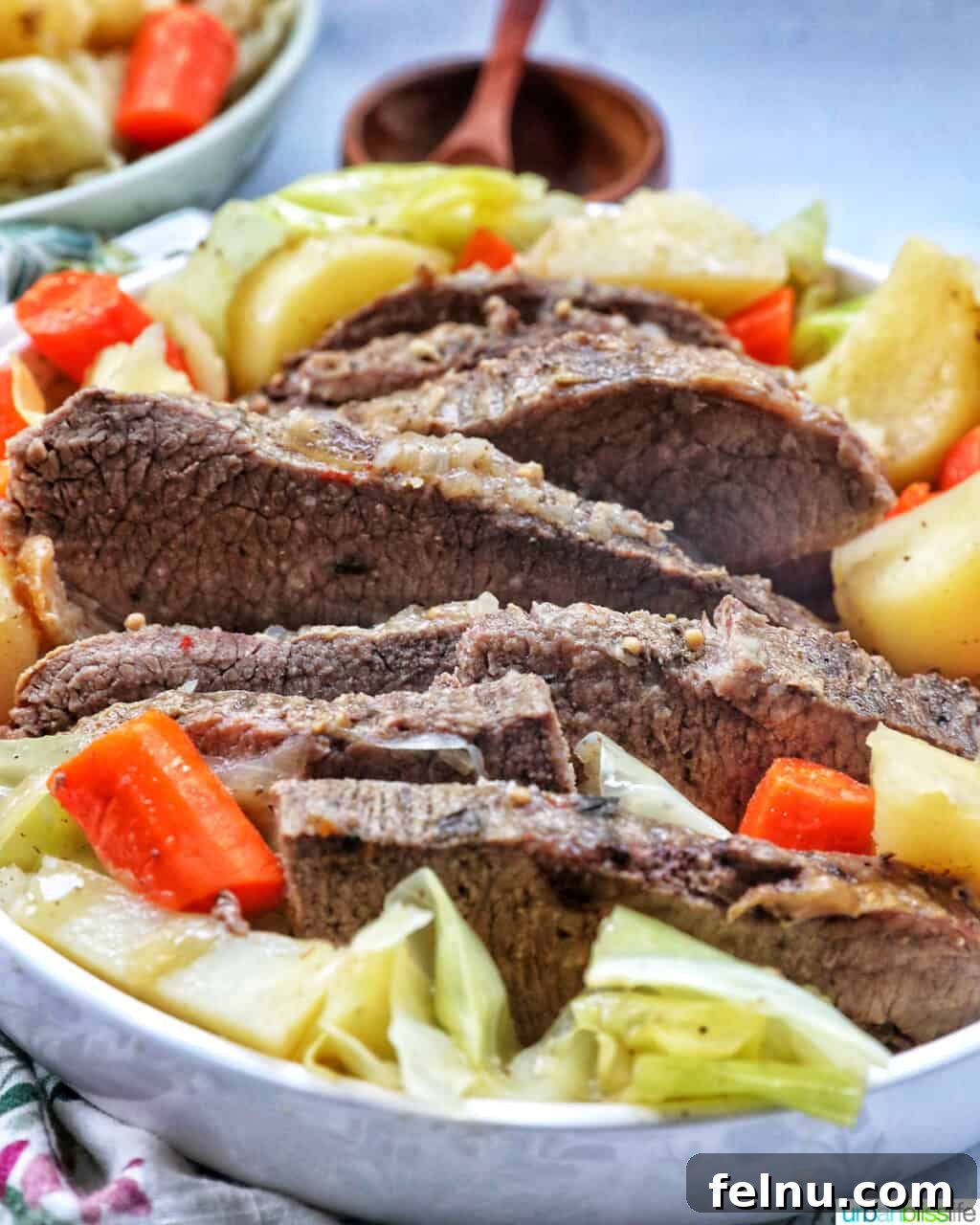 Tender Dutch Oven Brisket 3 bowl of sliced dutch oven brisket with carrots, potatoes, and cabbage.