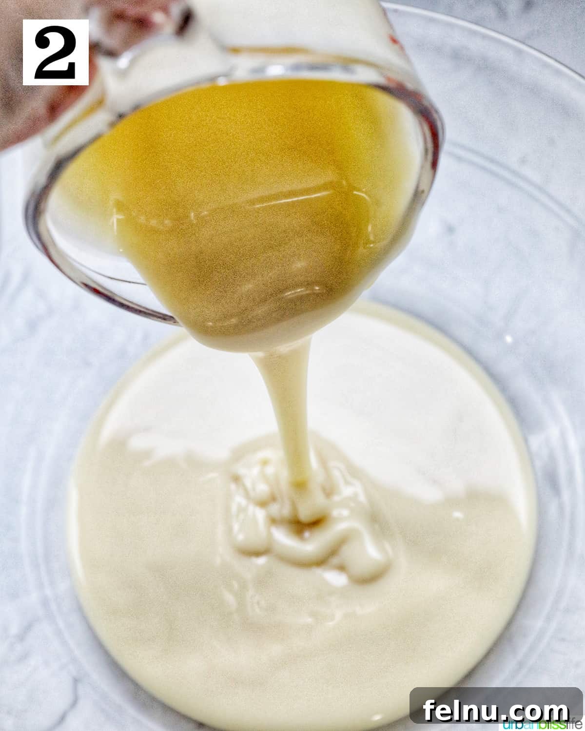 Pouring sweetened condensed milk into a large glass bowl