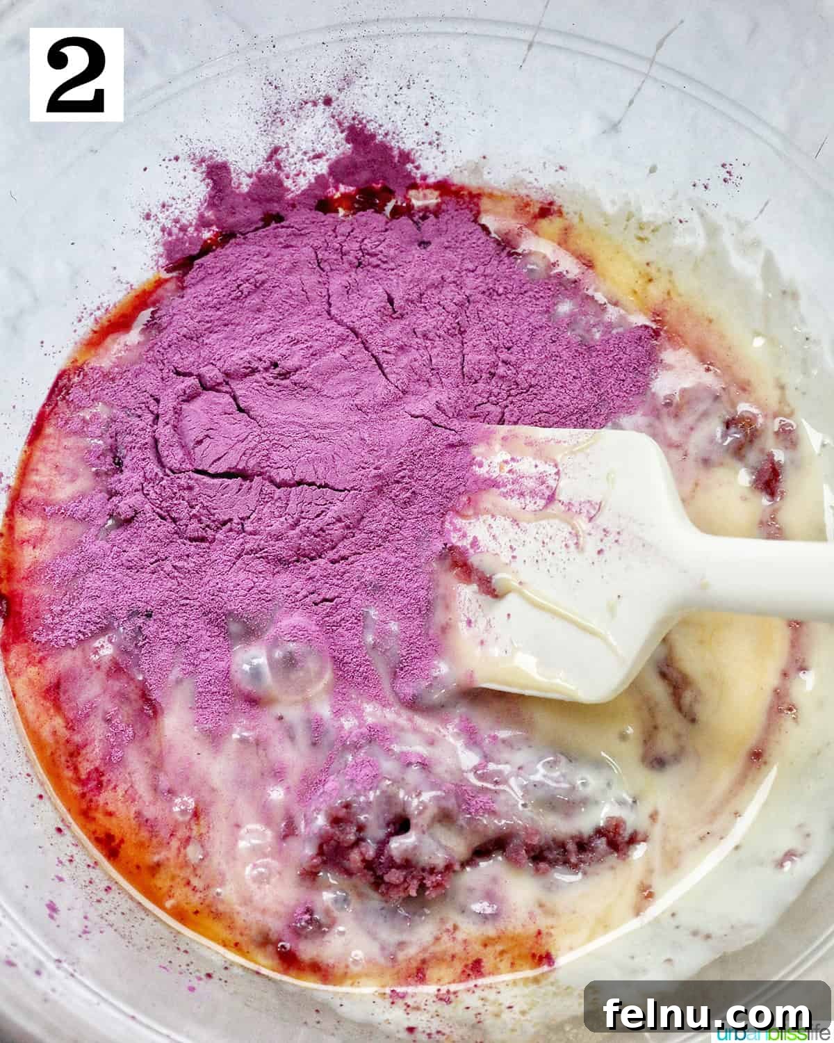 Mixing together ingredients to make ube ice cream in a large bowl