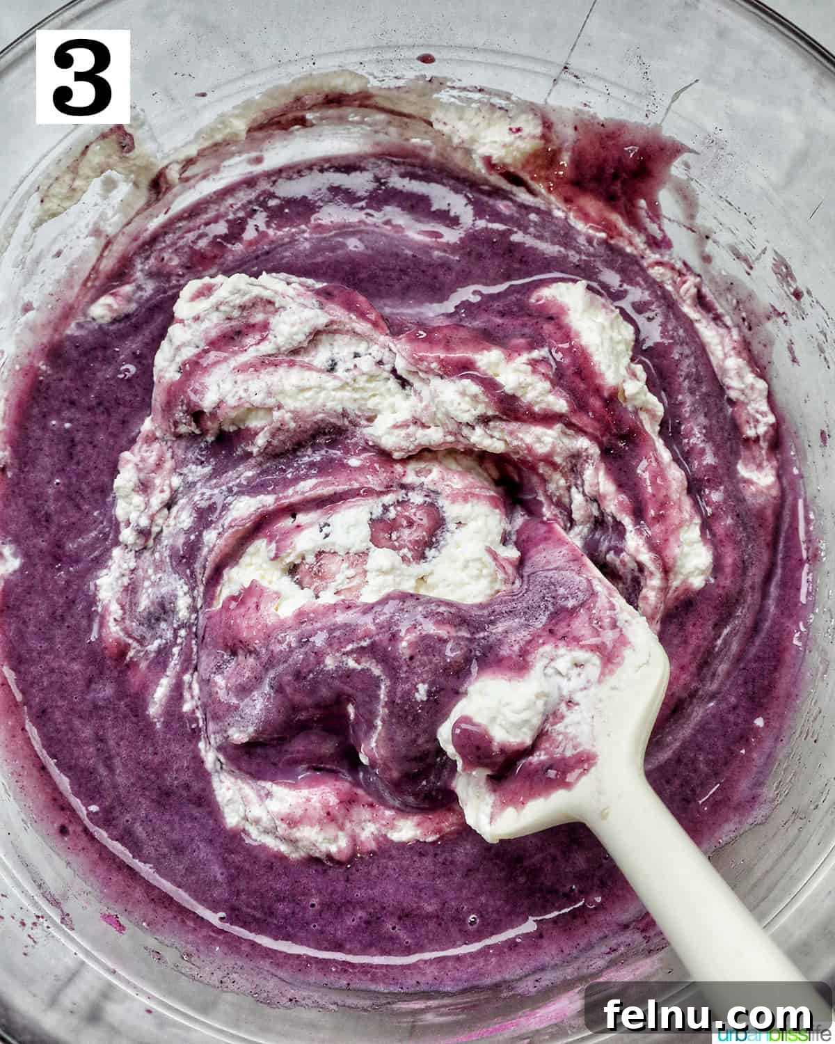 Folding in whipped cream to the ube ice cream base
