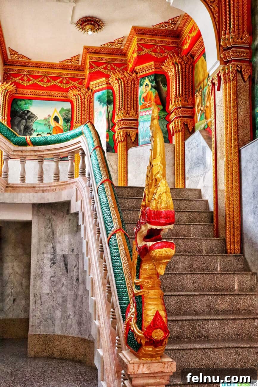 Wat Chalong Temple: A Spiritual Journey in Phuket 9 A colorful staircase with intricate architectural detail in the prayer hall of Wat Chalong temple in Phuket, Thailand.