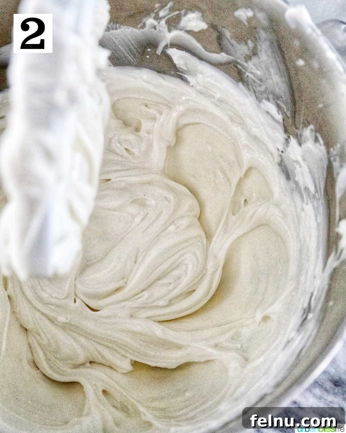Easter Egg Delight Cheesecake 14 Adding sour cream to the mixture.