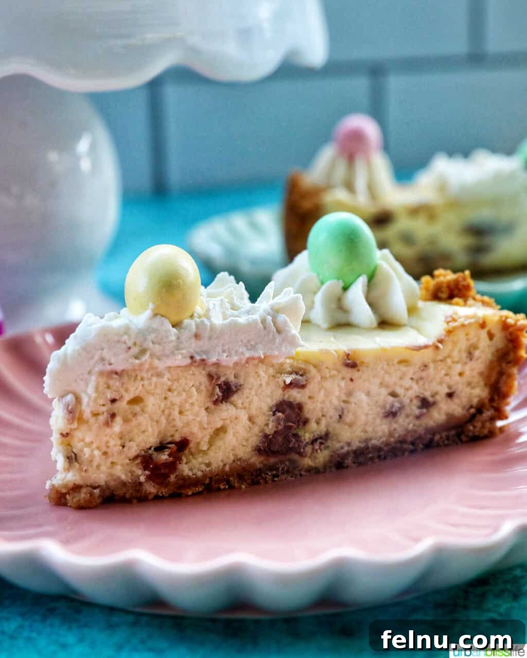 Easter Egg Delight Cheesecake 21 A slice of Easter egg cheesecake on a pink plate.
