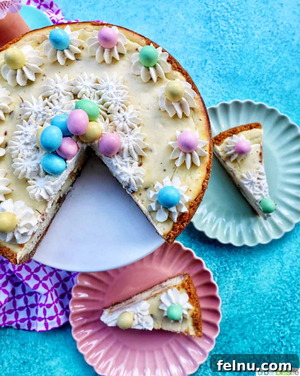 Easter Egg Delight Cheesecake 22 Easter egg cheesecake with two slices served on plates.