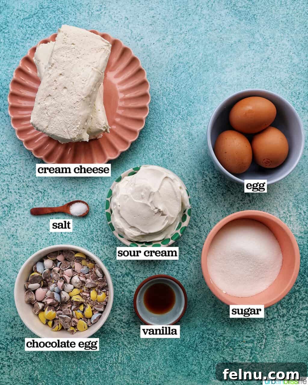 Easter Egg Delight Cheesecake 5 Ingredients for the cheesecake filling: cream cheese, sugar, sour cream, eggs, vanilla extract, salt, and mini chocolate eggs.
